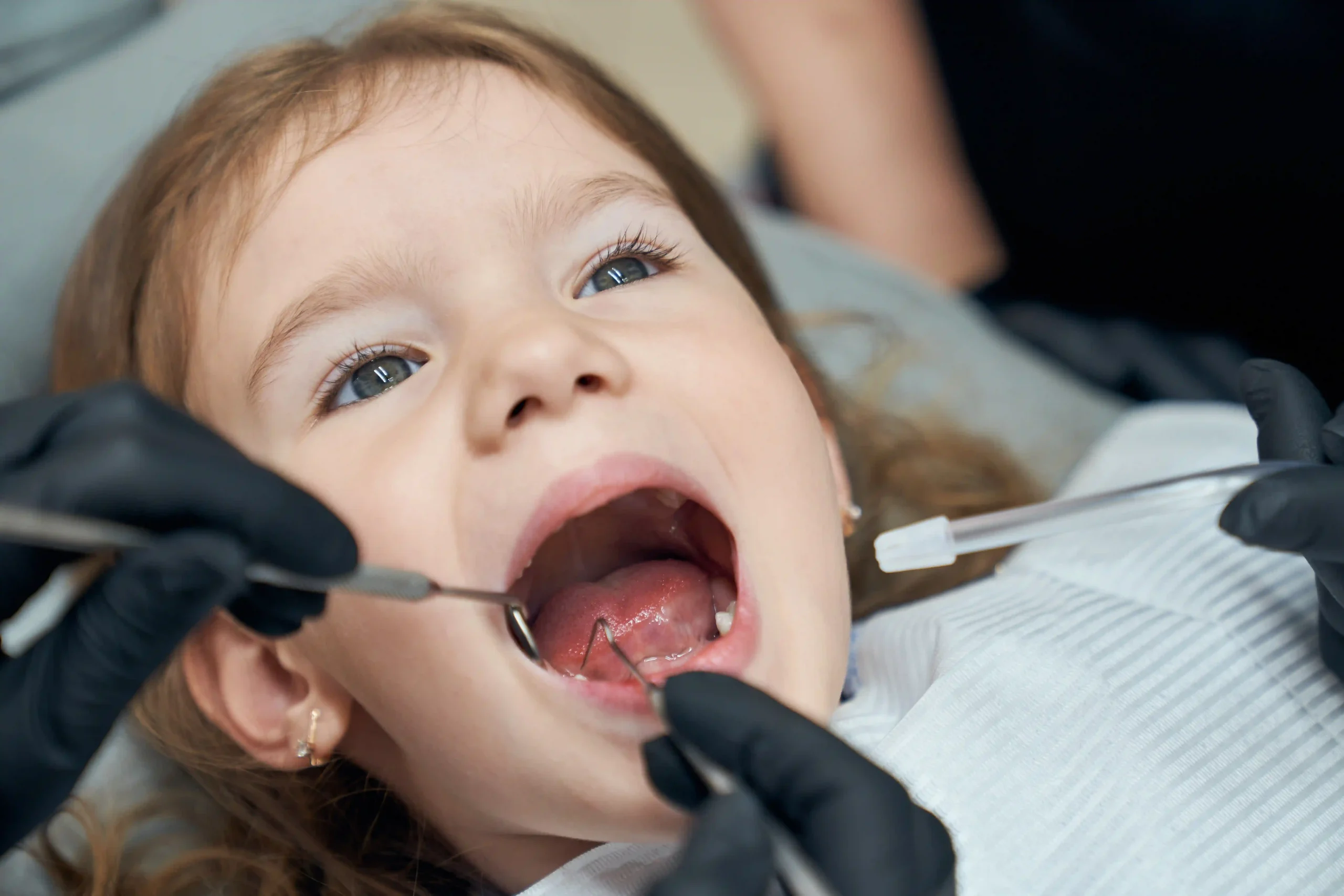 dentist-examining-condition-teeth-little-patient
